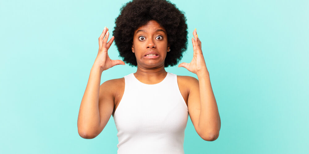 Afro,Black,Woman,Screaming,With,Hands,Up,In,The,Air,