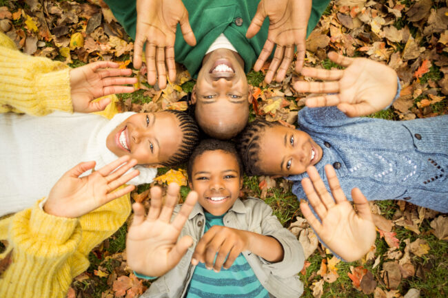 Young,Family,Doing,A,Head,Circles,And,Raising,Their,Hands