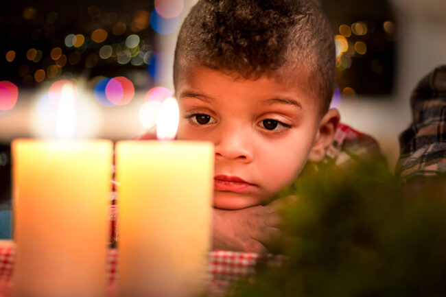 Upset,Child,Looking,At,Candle.,Sad,Boy,Beside,Christmas,Candles.