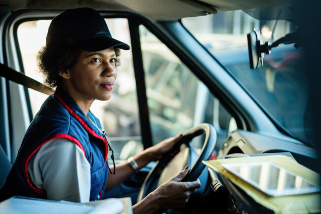 African,American,Female,Courier,Driving,Delivery,Van,In,The,City.