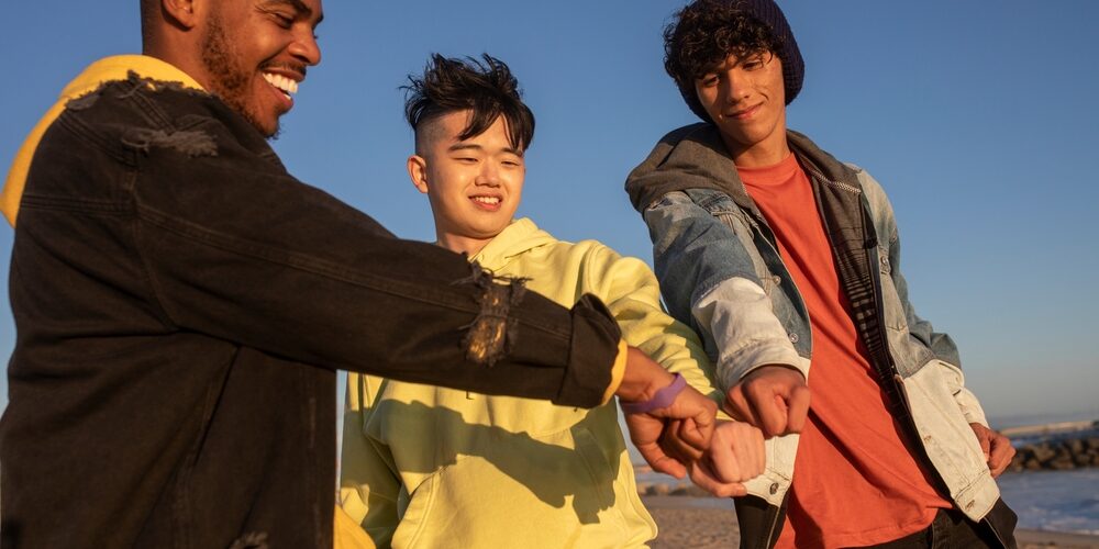Hands,Together,,Best,Friends,Teen,Boys,On,The,Beach