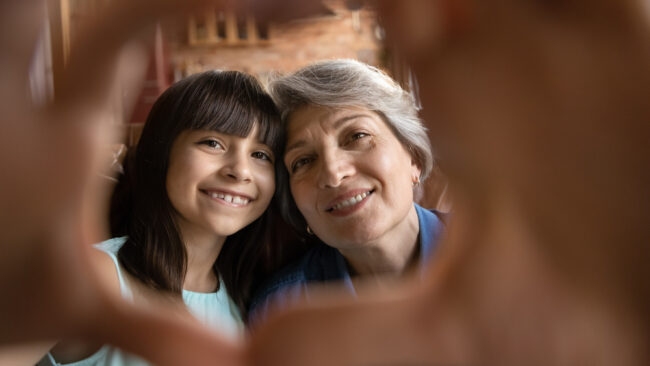 Close,Up,Portrait,Of,Smiling,Mature,Hispanic,Grandmother,And,Little