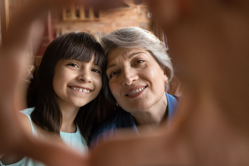 Close,Up,Portrait,Of,Smiling,Mature,Hispanic,Grandmother,And,Little