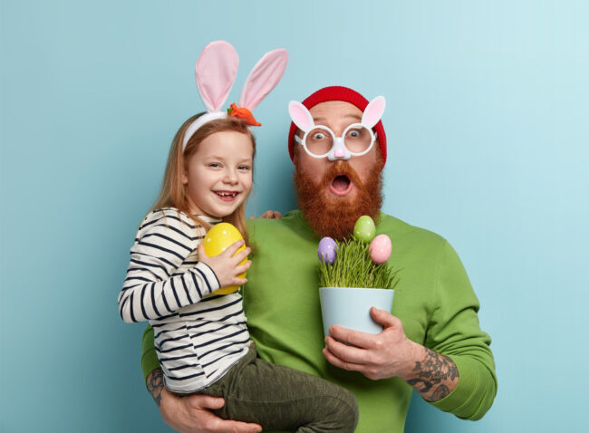 man-with-ginger-beard-wearing-colorful-clothes-holding-his-daughter