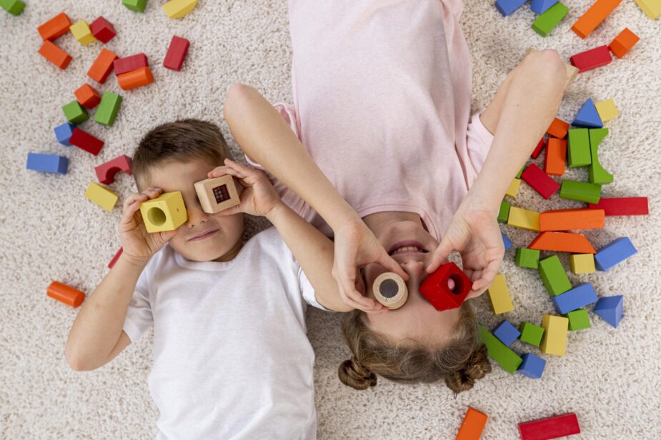 top-view-non-binary-kids-playing-with-colorful-game